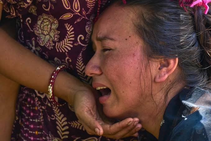 A woman receives support during flood response in Nepal